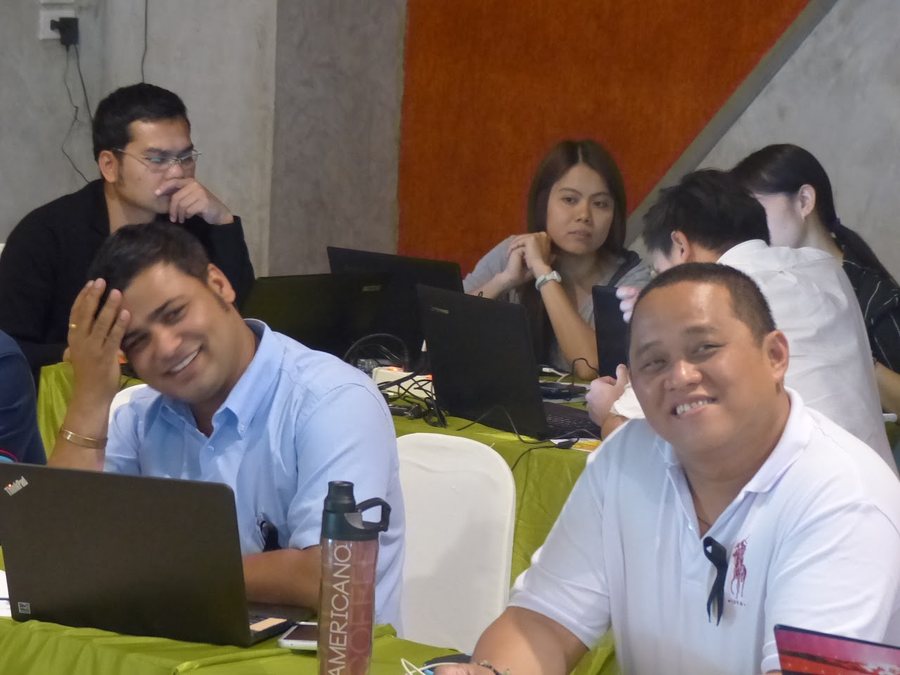 Trainees working through data analysis in a module session